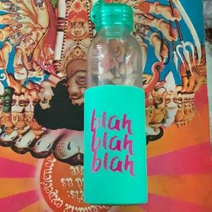 Glass water bottle with teal rubber cover. Green plastic twist lid